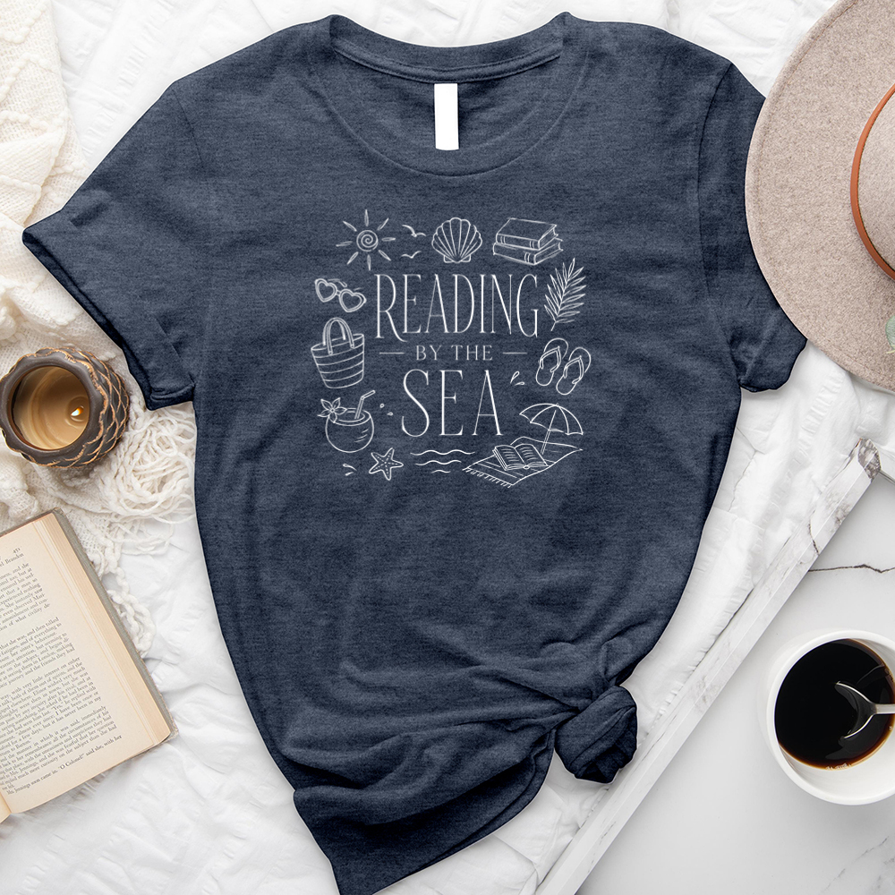 reading by the sea unisex tee