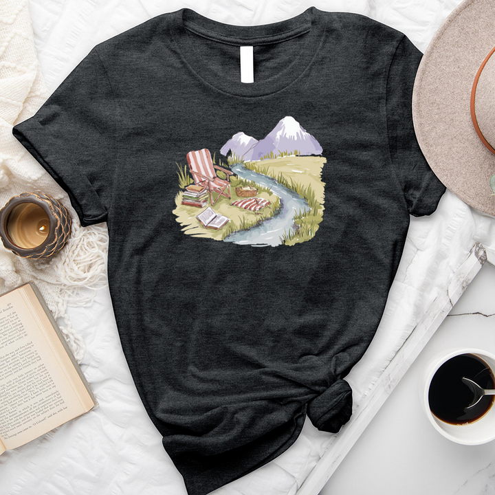 reading by the stream unisex tee