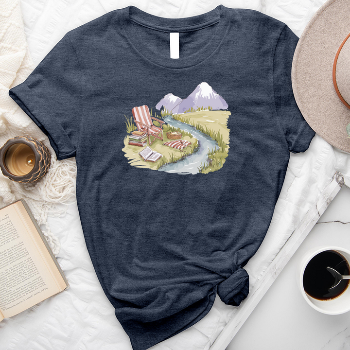 reading by the stream unisex tee