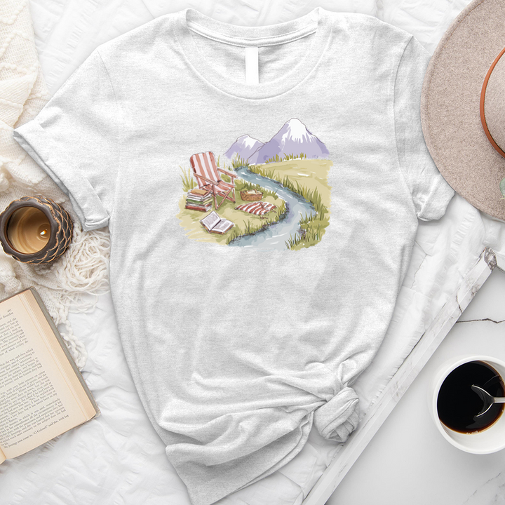 reading by the stream unisex tee