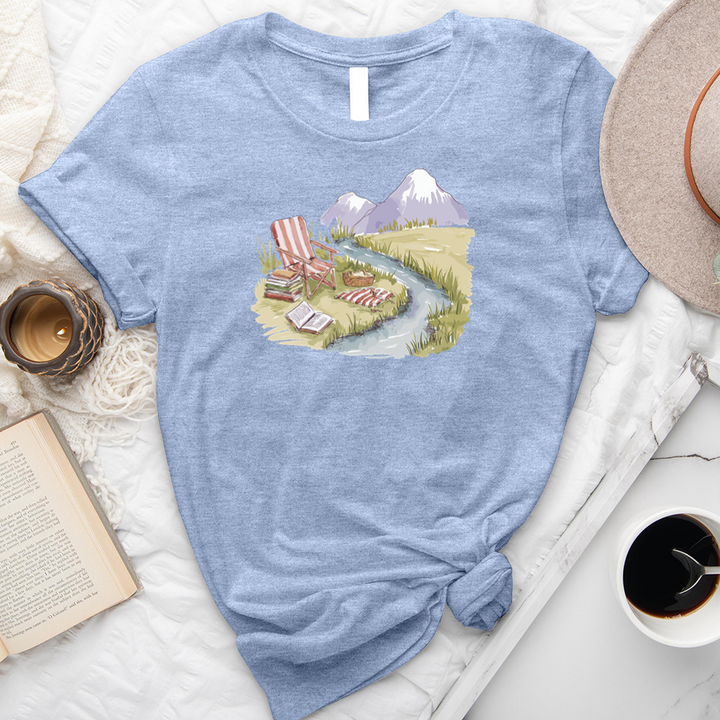 reading by the stream unisex tee