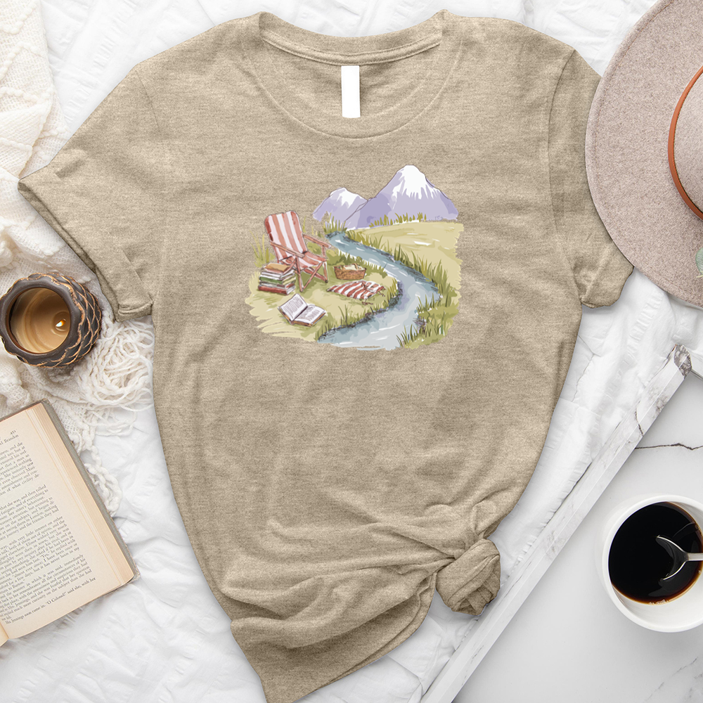 reading by the stream unisex tee