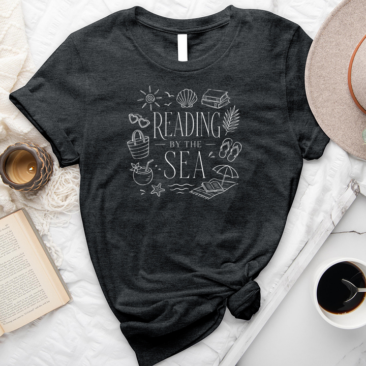 reading by the sea unisex tee